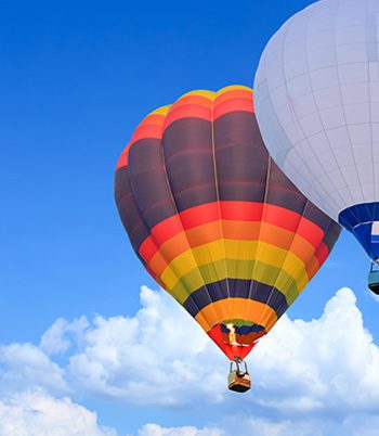 Two colorful hot air balloons floating in the sky