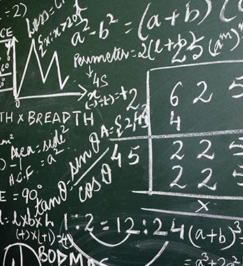 A photo of various mathematical equations on a chalkboard
